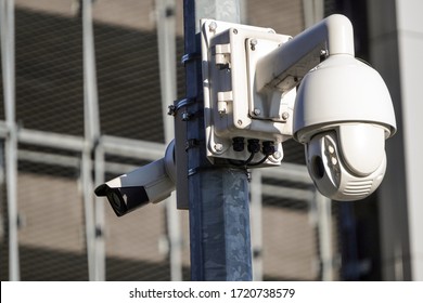 Two Cameras CCTV On The Facade Of A Modern Office Building On The Street, Security In The City. Covert Shooting Of What Is Happening. Modern Technologies And Equipment