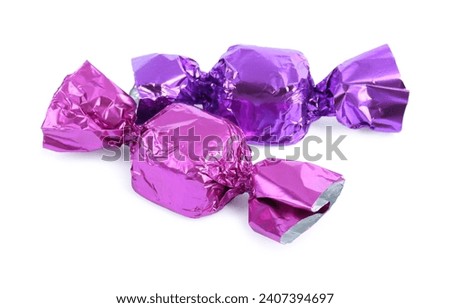 Two candies in colorful wrappers isolated on white