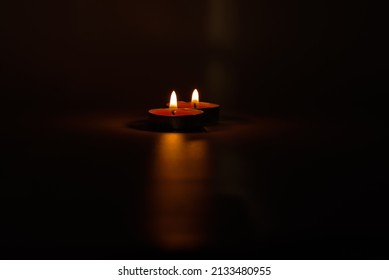 Two Candles Burning In A Black Background. The Concept Of Grief, Sorrow Or Grief. 