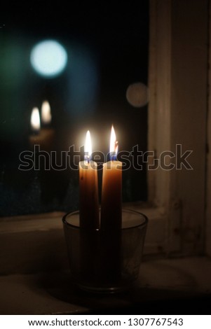 Two candles on windowsill