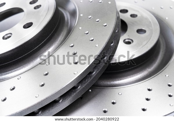 Two car brake disc background
texture. Auto spare parts. Perforated brake disc rotor. Braking
ventilated discs. Quality spare parts for car service or
maintenance
