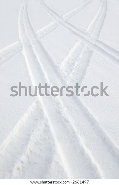 Two car tracks on\
snow