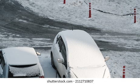 Two Cars Are Covered With Snow On A Winter Day In A Street Parking Lot