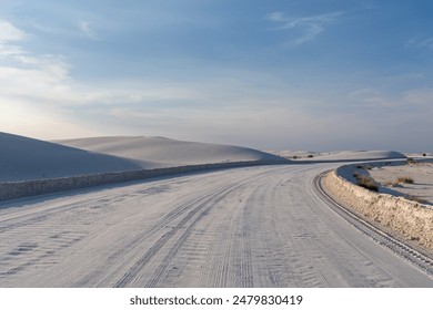 Two cars driving on a snow-covered desert road - Powered by Shutterstock