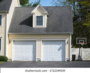 Two Cars Garage Door Painted In White Color In A Typical Single House