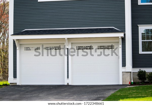 Two cars Garage Door painted in Black color in a\
typical single house