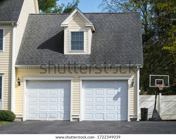 Two cars Garage Door painted in White color in a\
typical single house