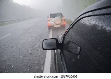 Two cars in heavy stormy rain and hail