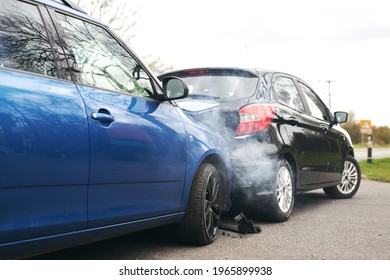Two cars involved in traffic accident on side of the road with damage to bonnet and fender - Shutterstock ID 1965899938