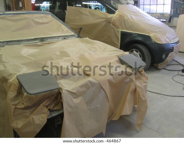 Two cars made ready for\
a paint job.