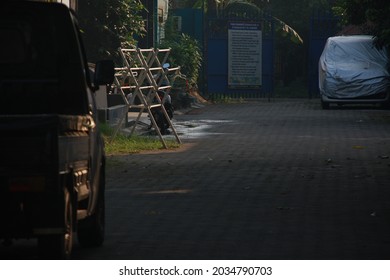 Two Cars Parked On A Public Street In The Morning