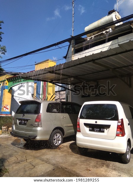 two cars parked under the canopy,\
location: Surakarta, Central Java, Indonesia, 27 May\
2021