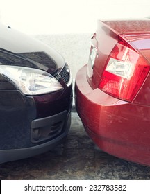 Two Cars Parked Very Close To Each Other 