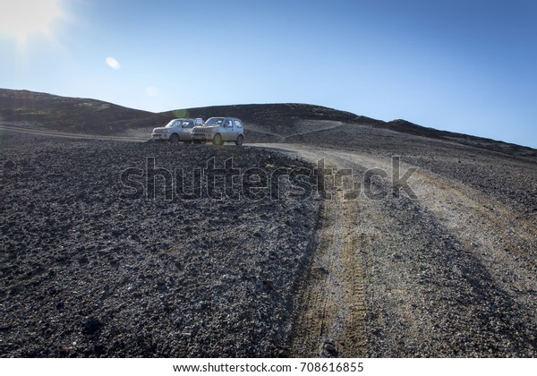 two cars parking\
on mountain road in iceland