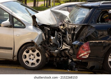 Two cars are seen on the road after a crash. - Shutterstock ID 2152268153