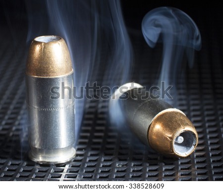 Two cartridges with hollow point bullets and smoke