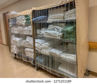 Two Carts With Bedding Linens In Hospital Corridor