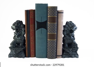 Two Carved Marble Lion Bookends Supporting A Few Books