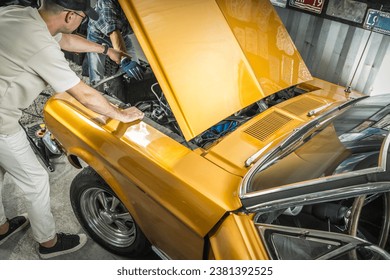 Two Caucasian American Classic Cars Enthusiasts Working on the Vehicle Engine - Powered by Shutterstock