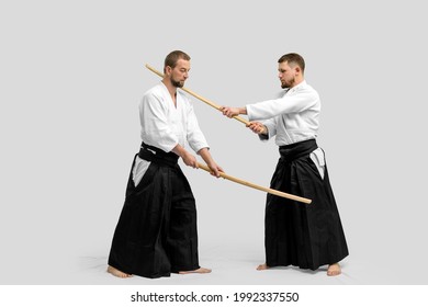 Two caucasian men are practicing aikido with Bokken (isolation path included)