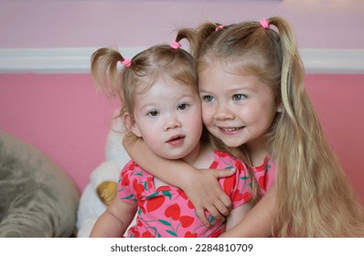 Two caucasian sisters in matching clothes hugging. Sister's love concept. Siblings hugging  - Shutterstock ID 2284810709