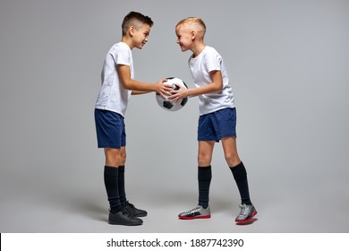 Two Caucasian Soccer Players Stand Opposite Each Other Sharing One Ball, Looking At Each Other, Going To Play, Hold Match