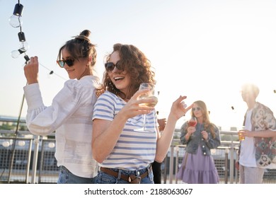 Two caucasian women dancing at the rooftop in summer day  - Powered by Shutterstock