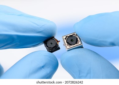 Two Cell Phone Camera Modules In Scientist Hands.