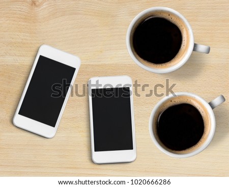 Two cell phones and two coffee cup