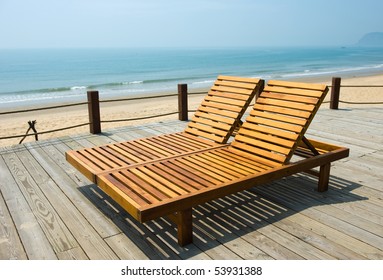 Two Chairs By The Beach Shore.