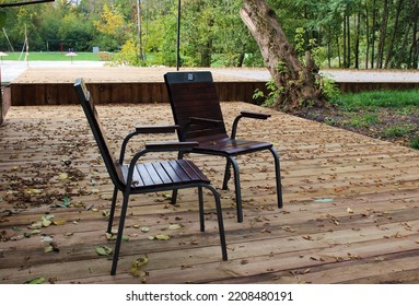 Two Chairs With Foliage On A Wooden Deck Floor