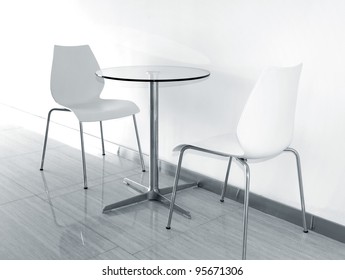 Two Chairs And Glass Coffee Table