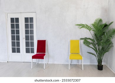 Two chairs in the interior of an empty white room