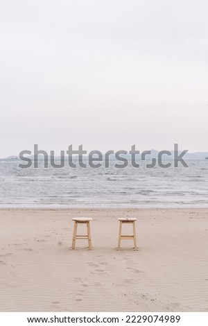 Two chairs lying on the beach with a comfortable and peaceful feeling