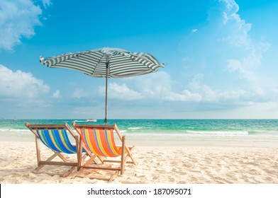 Two Chairs And Umbrella At The Beach