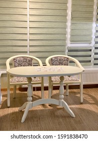 two chairs and a white table