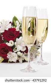 Two Champagne Flutes With Wedding Bouquet