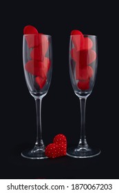 Two Champagne Glasses With Red Hearts For Couple On Black Background. Happy Valentines Day Dinner. 14 February. Greeting Card, Banner. Vertical