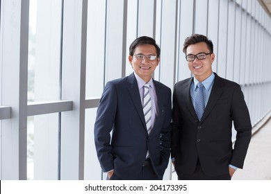 Two Cheerful Asian Business People: Father And Son