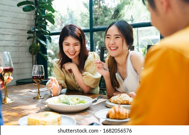 Two cheerful asian thai woman enjoy eating brunch with friends in restaurant. - Shutterstock ID 1682056576