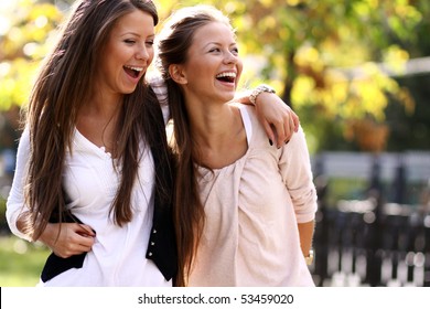 Two cheerful girls twins, in the street - Shutterstock ID 53459020