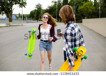 Similar – Happy young woman riding on skate with her friends