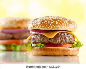 two cheeseburgers with selective focus on the foreground burger - Powered by Shutterstock