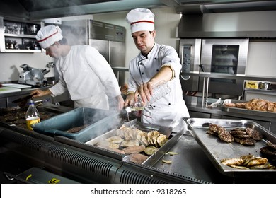 Two Chefs At Work In A Restaurant