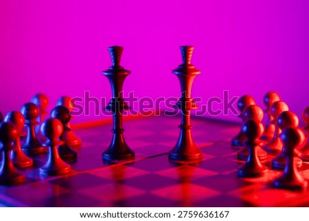 Two chess kings facing each other with a group of supporting pieces in vibrant lighting, concept of political polarization, elections, and confrontation