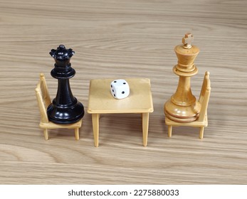 Two chess queens sit facing each other   play game