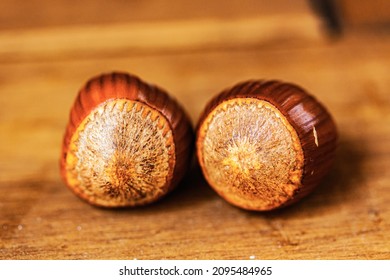 Two Chestnuts On A Wooden Table