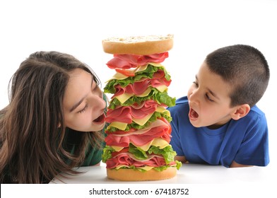 Two Child Eating Big Tower Sandwich Isolated On White Background.