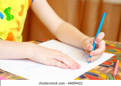 Two Child Hands Drawing A Picture With Pencil