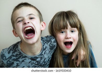 Two children boy and girl fooling around having fun together. Happy childhood concept.
